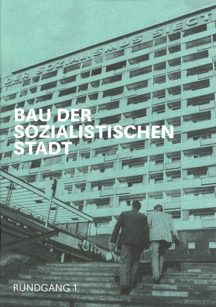 KI generiert: Das Bild zeigt ein hohes, mehrstöckiges Gebäude mit einer verkündenden Aufschrift im Stil des sozialistischen Realismus. Zwei Personen gehen die Treppenstufen hoch, darüber steht in großen weißen Buchstaben "BAU DER SOZIALISTISCHEN STADT".